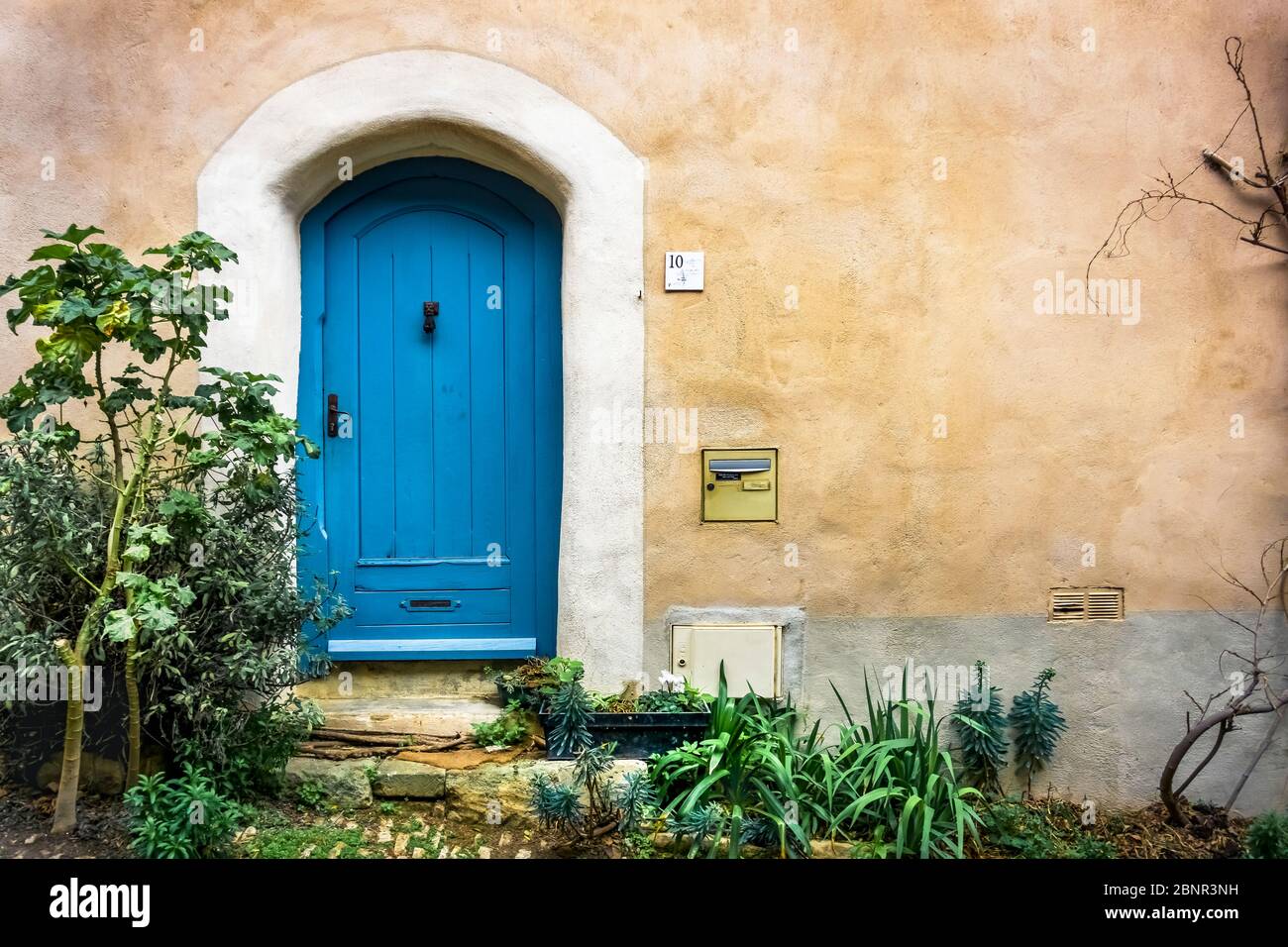 Old wooden door in Bages. Located in the Narbonnaise en Méditerranée Regional Nature Park. Stock Photo