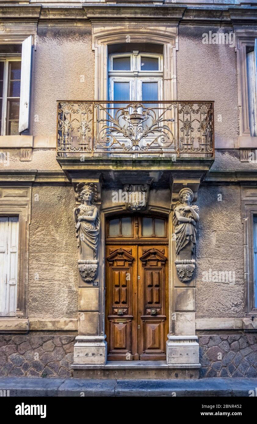 House facade with female figures as consoles in Capendu. Built in the XIX century. The place belongs to the round villages in the region. Stock Photo
