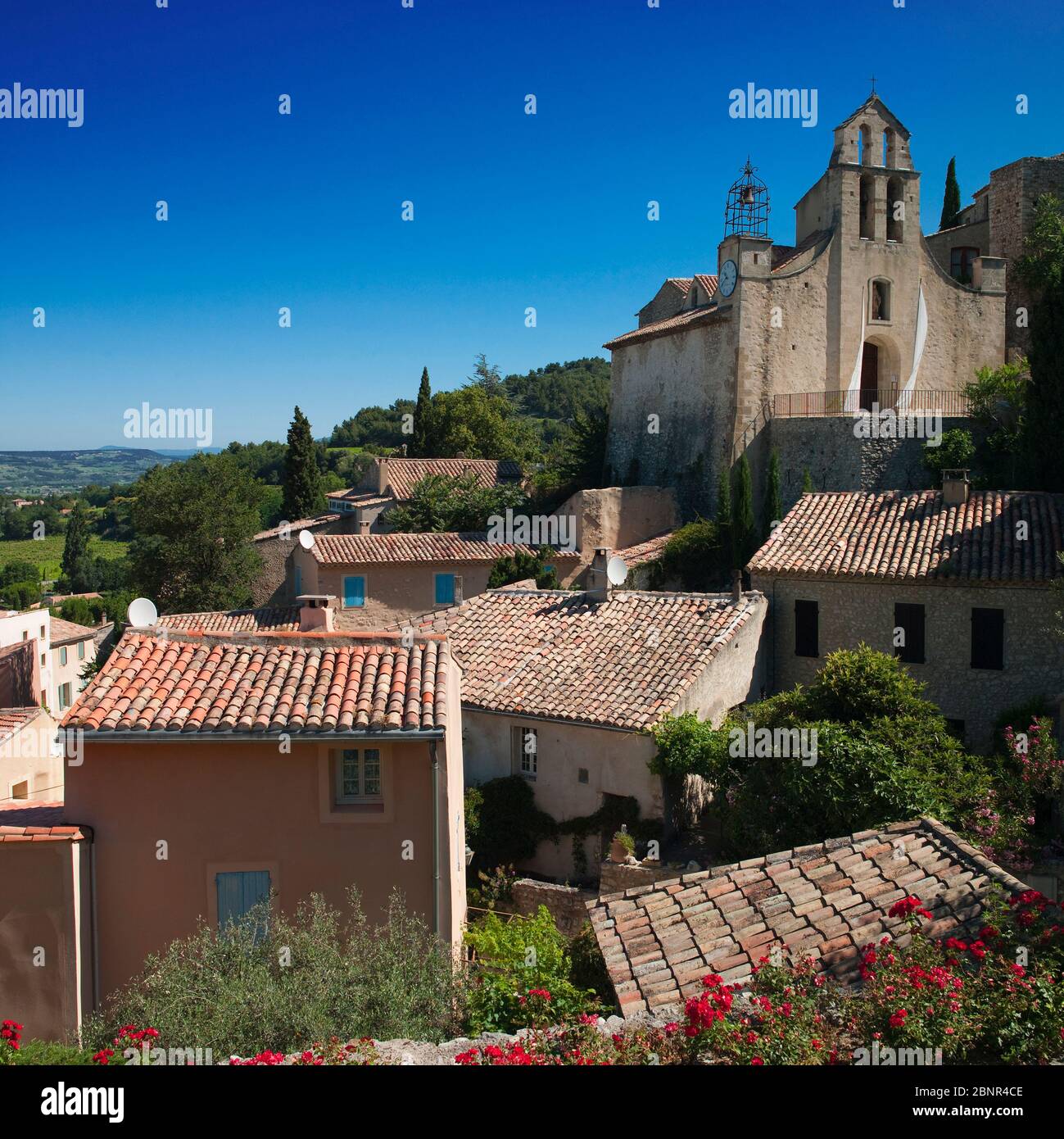 The 11th century Sainte Catherines Church in the old wine making village of Gigondas, Vaucluse, southern France surrounded by village houses in the he Stock Photo