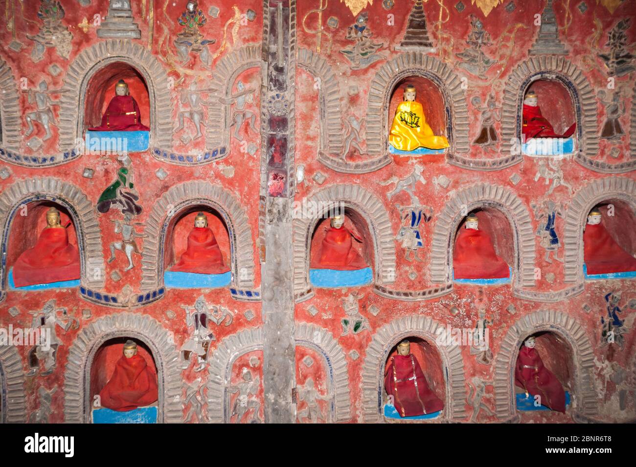 The Temple wall contains hundreds of Buddha statue's in alcove's the wall in Pagoda of Nyan Shwe Kgua temple near Inle lake,Shan state in Myanmar. Stock Photo