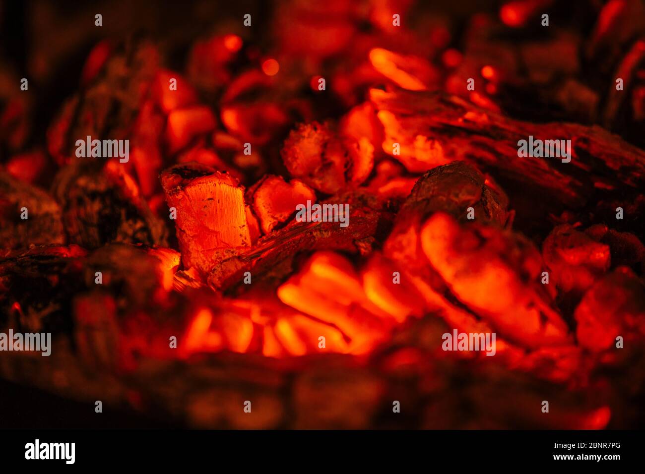 Burning orange embers from a fireplace to make grilled meat. Stock Photo
