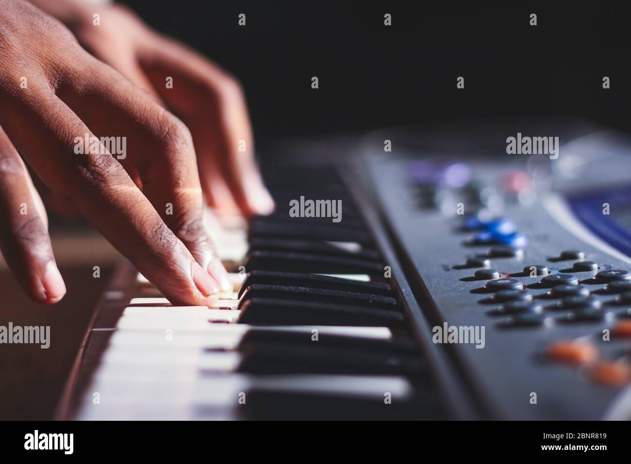 Music magician Playing the Electronic Keyboard in Music Recording