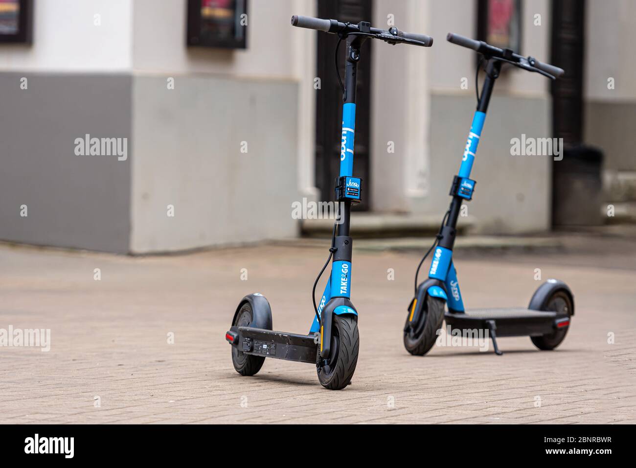 Riga, Latvia - May 14, 2020: two dockless rental electric scooters is  parked on the sidewalk, ecological urban transport concept Stock Photo -  Alamy