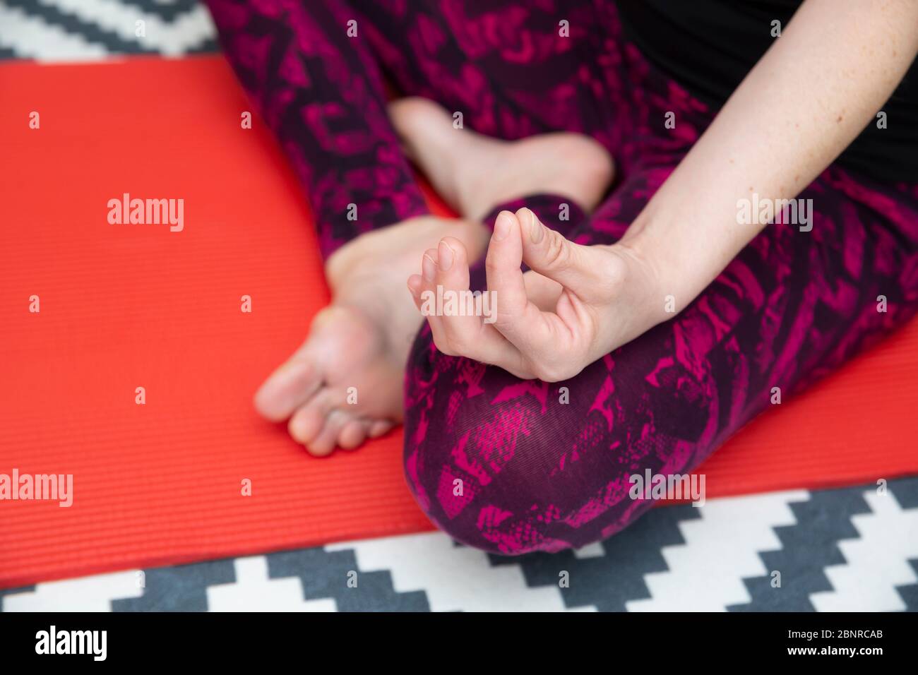 Beautiful young woman practicing yoga at home Stock Photo