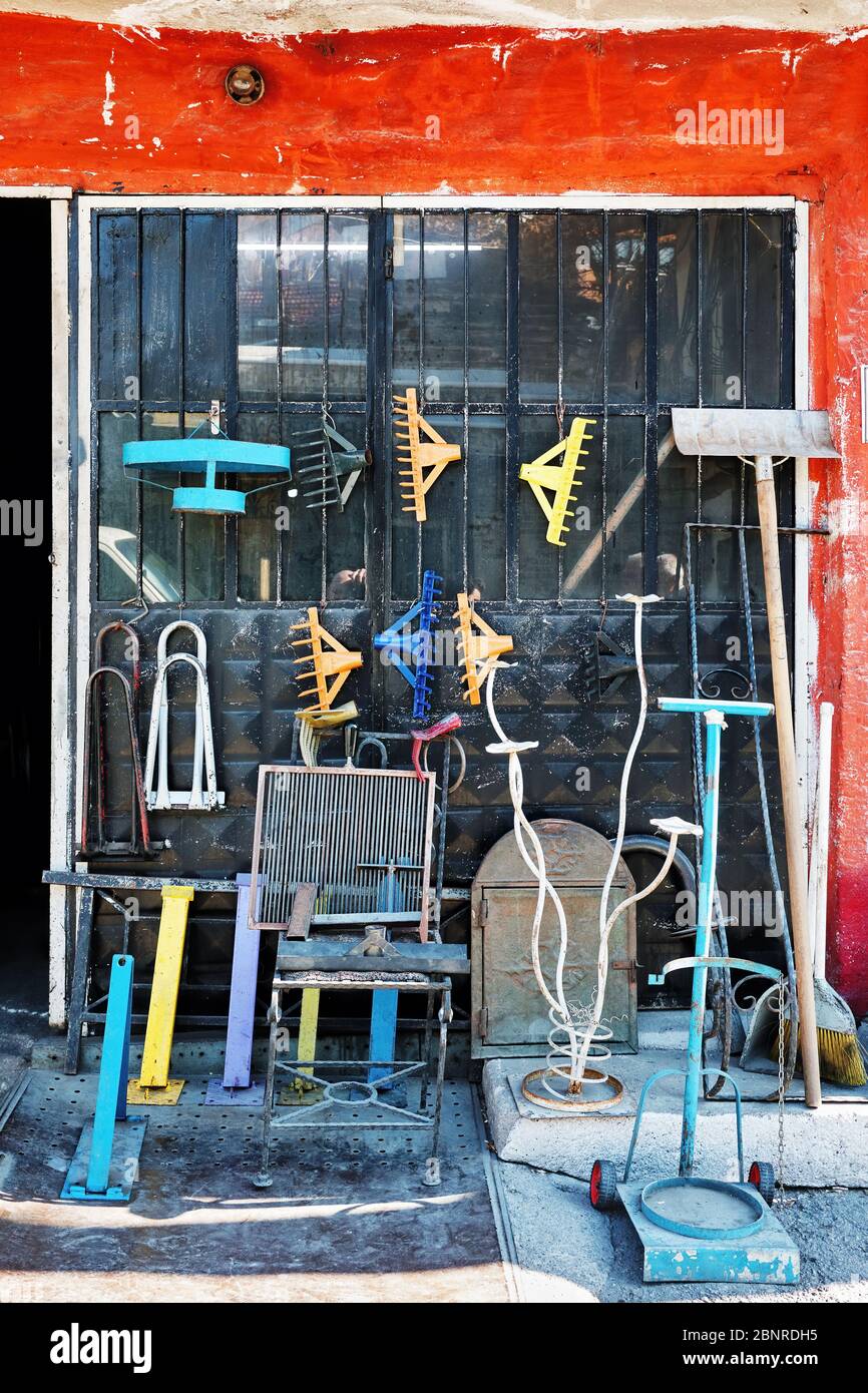 Exterior showcase of a rural hardware store with tools displayed on the