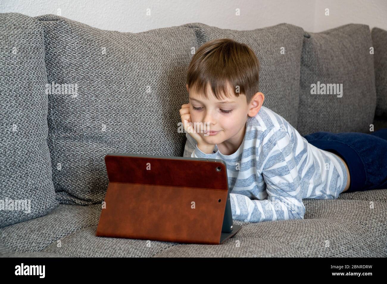 Distance learning online education. School kid using tablet for ...