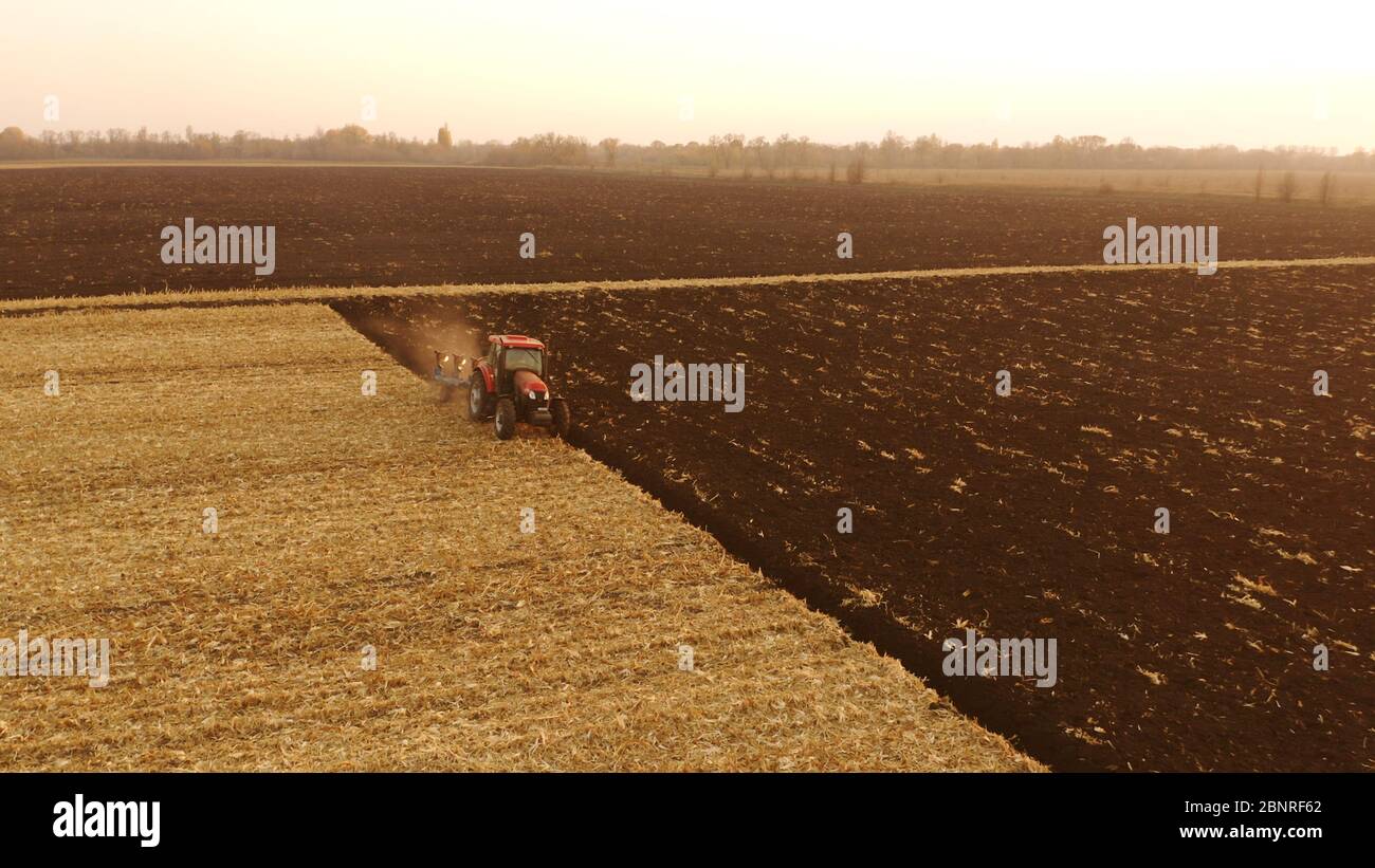 Tractor working on farm field in autumn time Stock Photo Alamy