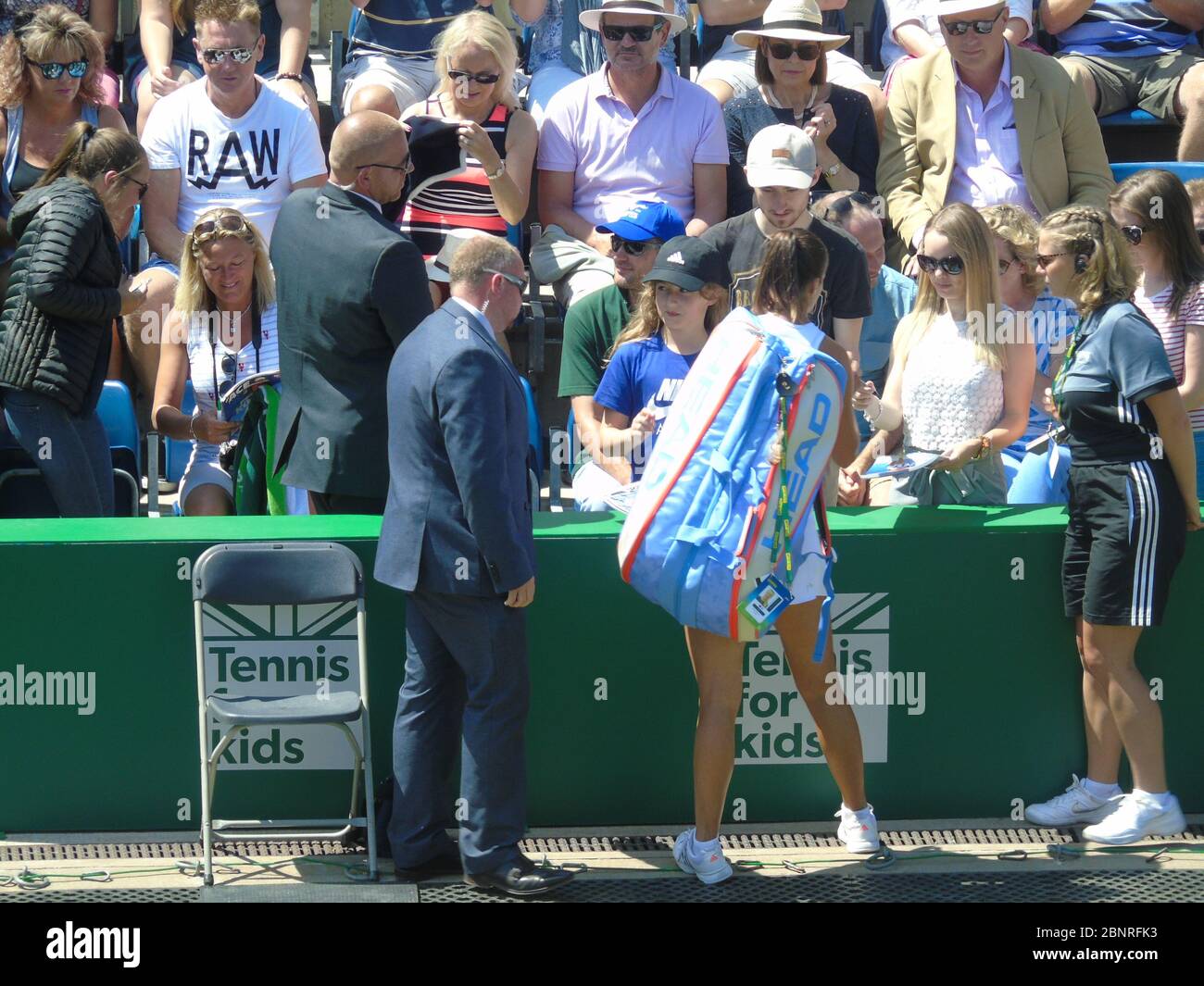 A professional world class female tennis player signing autographs for
