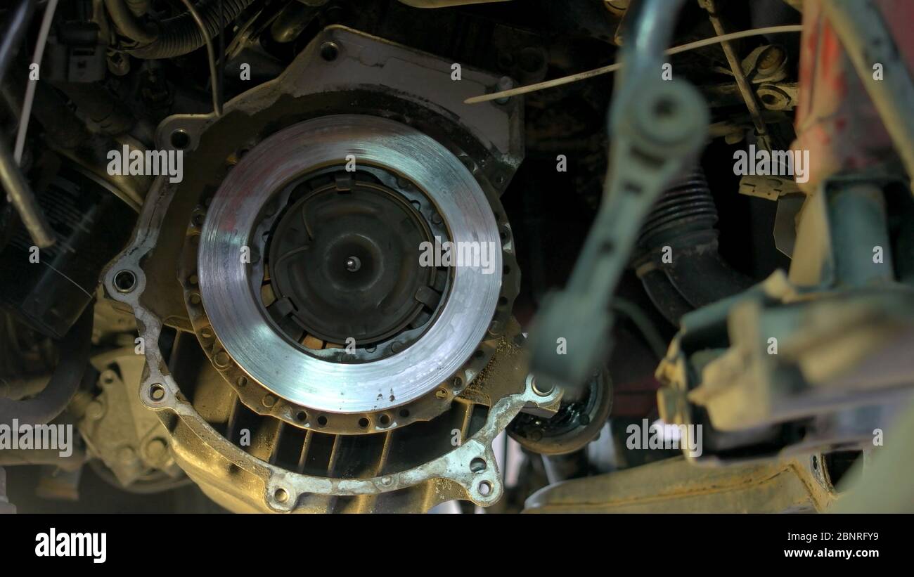 Mechanic installing bolts on a car clutch Stock Photo Alamy