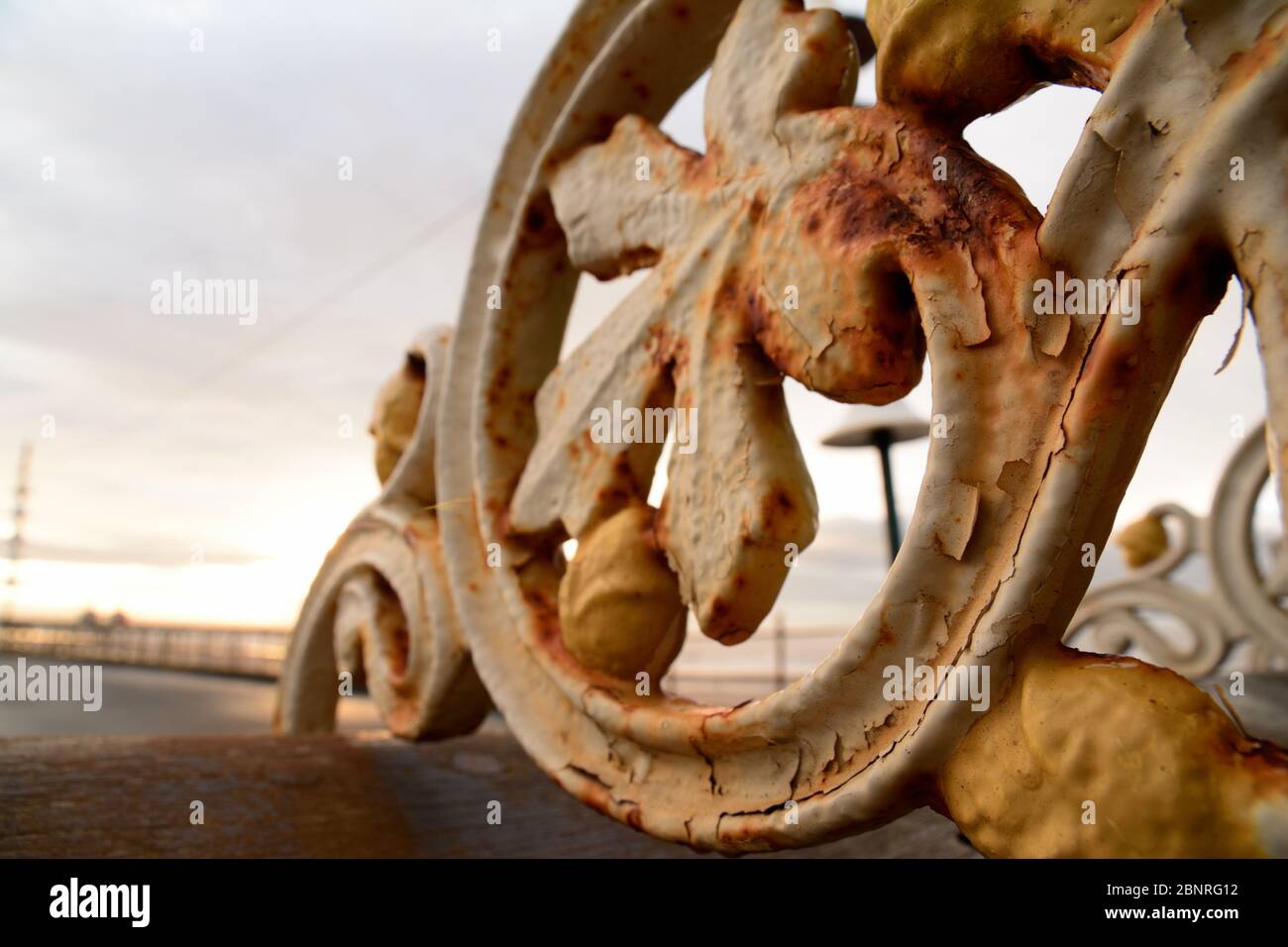 A rusted Victorian era iron bench in a UK coastal town Stock Photo - Alamy