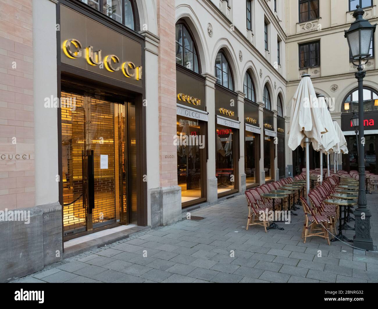 Shops closed on Corilian virus in Maximilianstrasse Munich. In the foreground a closed and closed café. Stock Photo