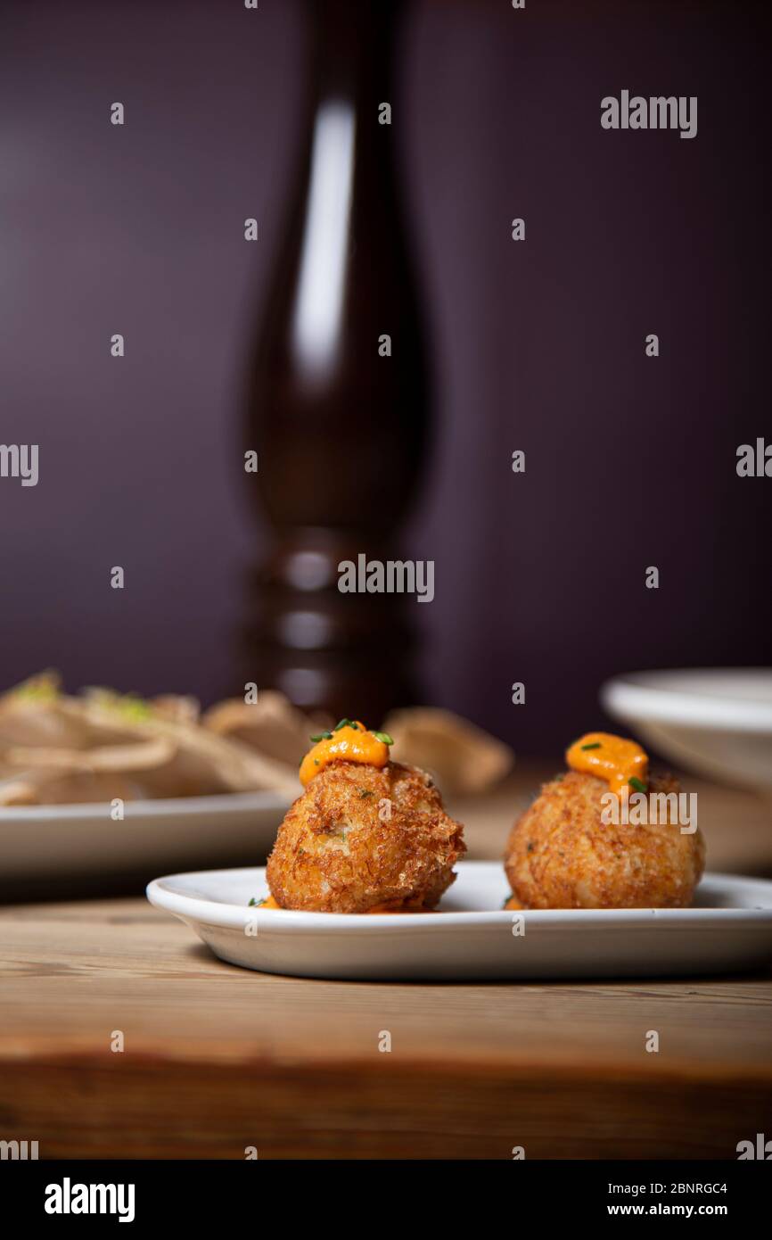 Cod fritters, traditional Spanish tapas on wooden table. Isolated image ...