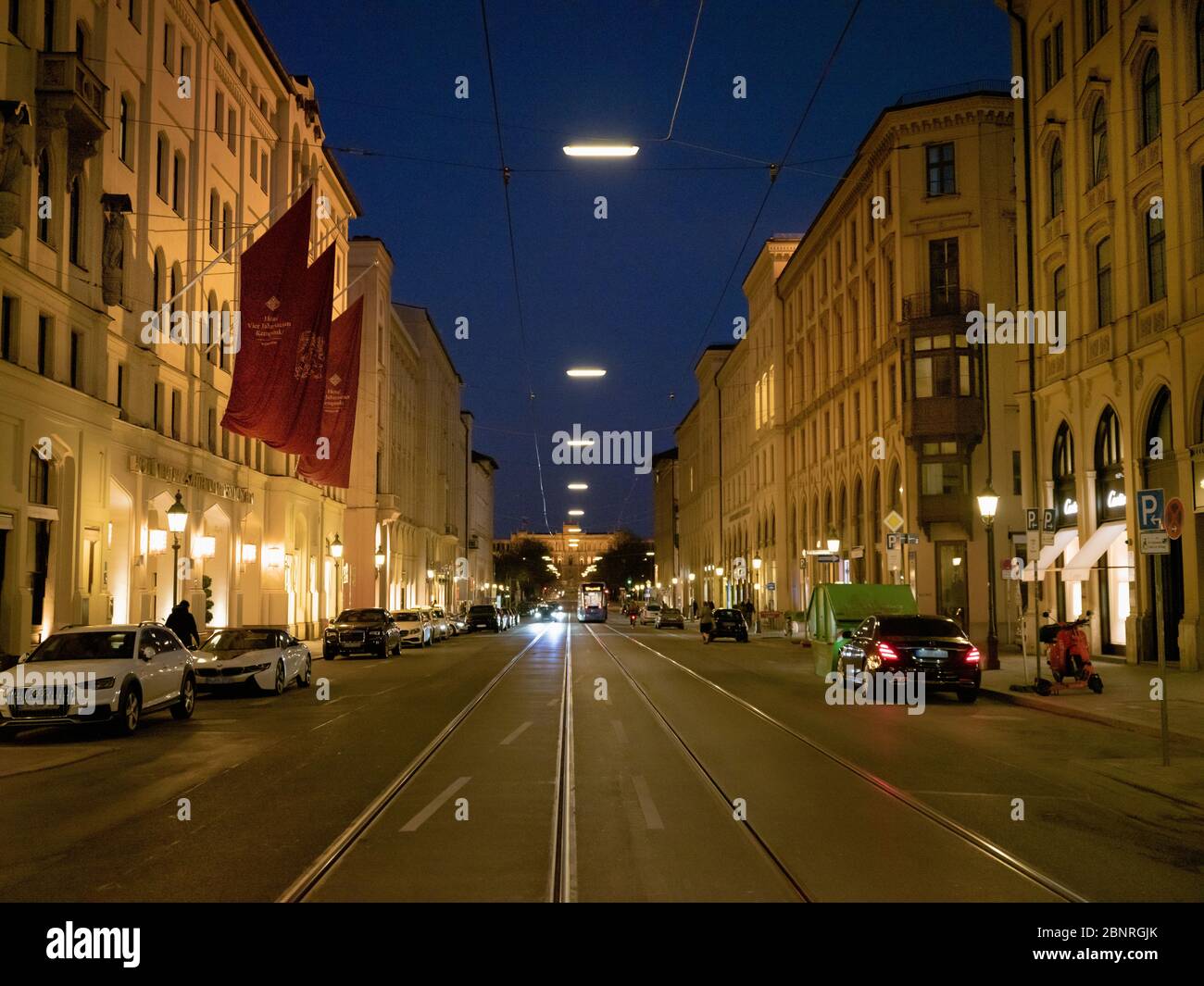 Munich's old town in Maximilianstrasse, car-free in front of the Hotel Kempinksi at the blue hour during the Corona Virus Stock Photo
