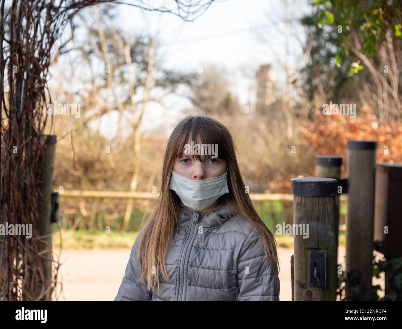 Preteen girl in the garden at times of corona crisis Stock Photo