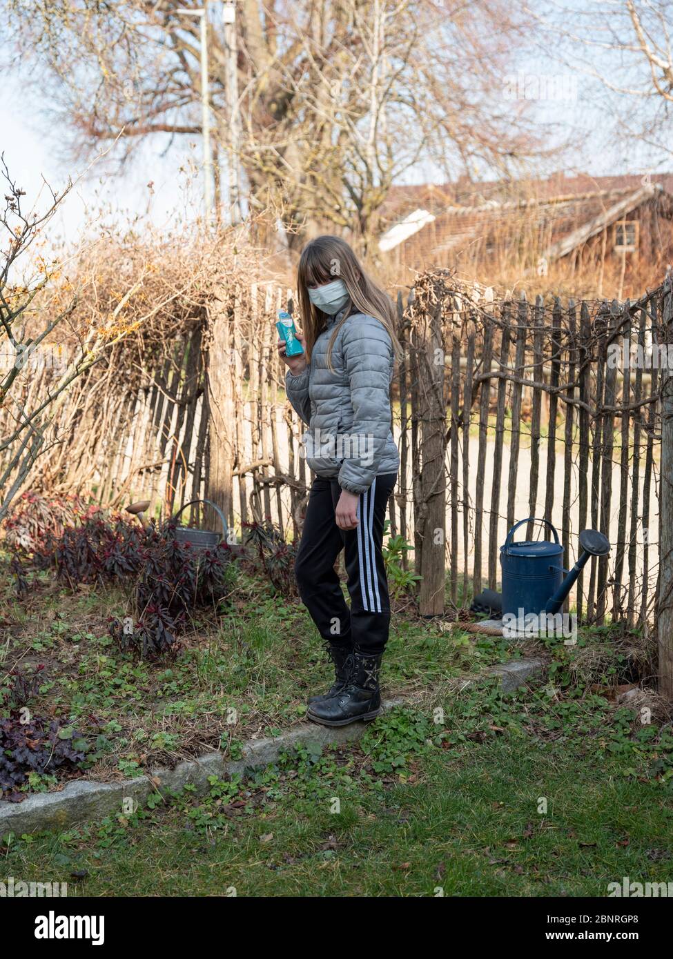 Preteen girl in the garden at times of corona crisis Stock Photo