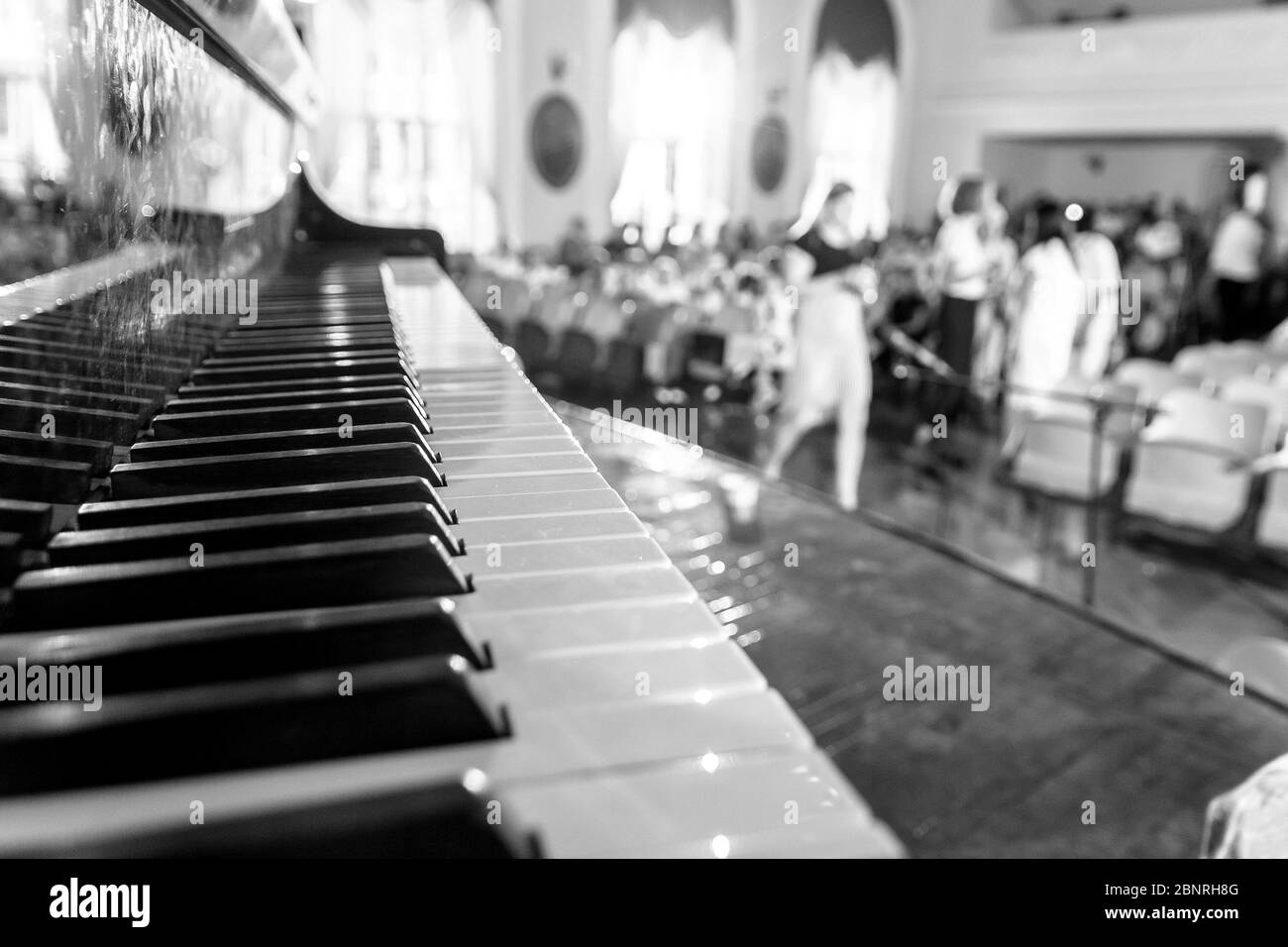 Piano keyboard in the hall with people Stock Photo