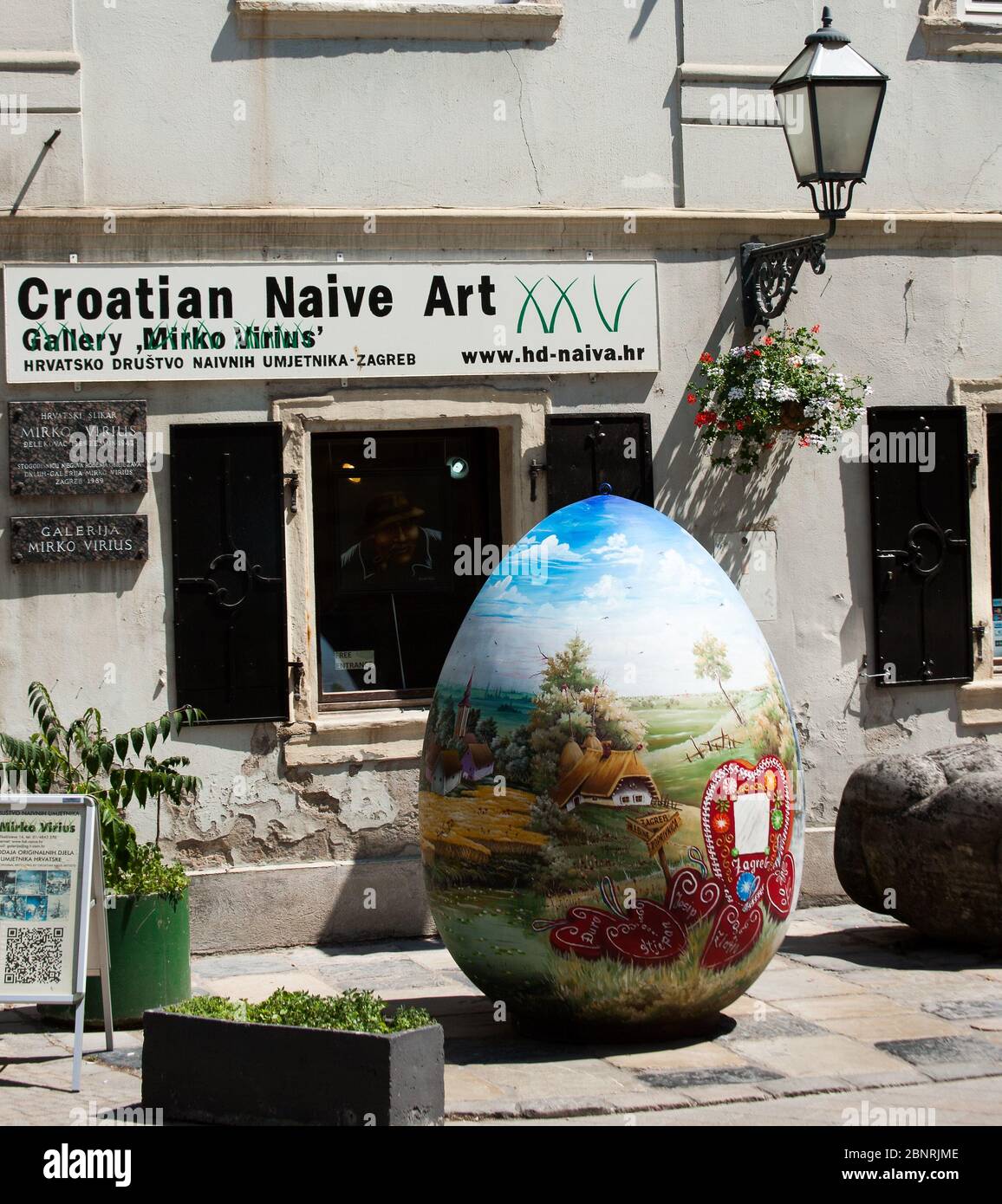 Outside infront of the Croatian Naive Art Gallery on the street in Zagreb is a large painted Easter egg Stock Photo