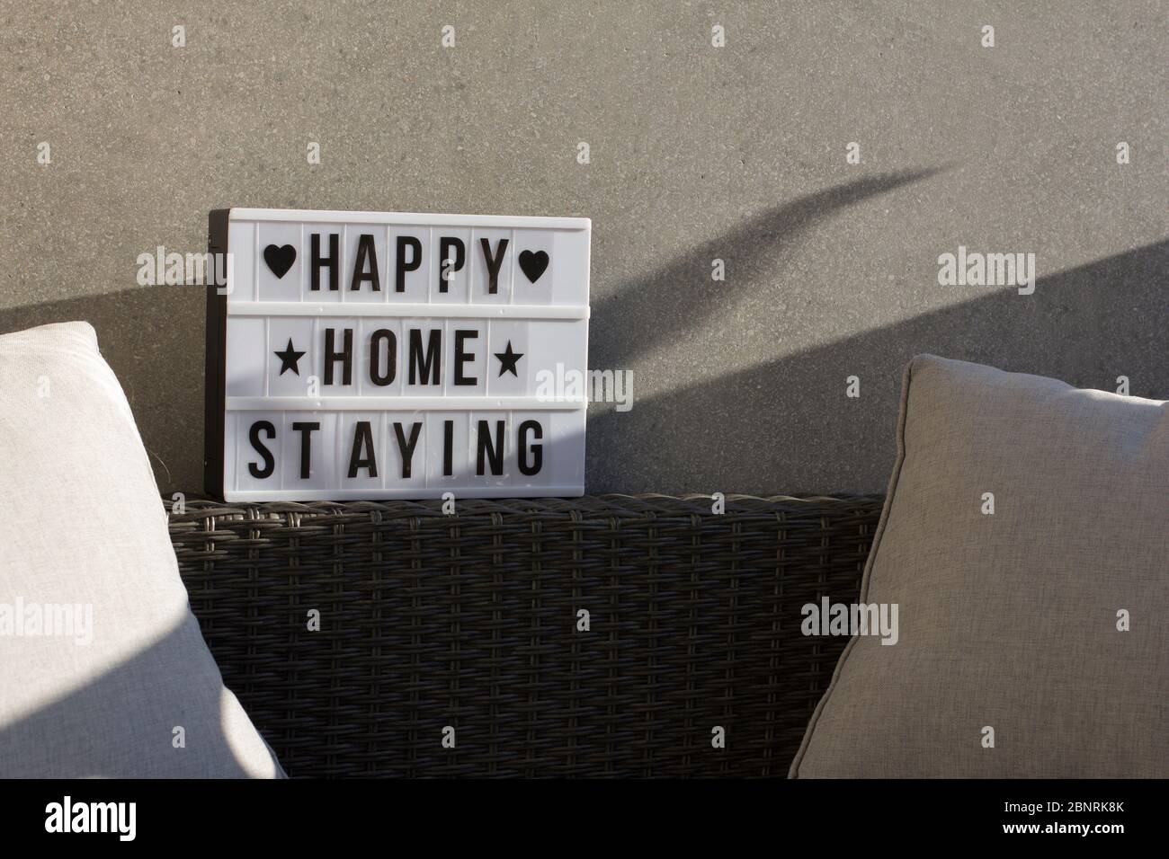 At home on the balcony, sign 'happy home staying' Stock Photo