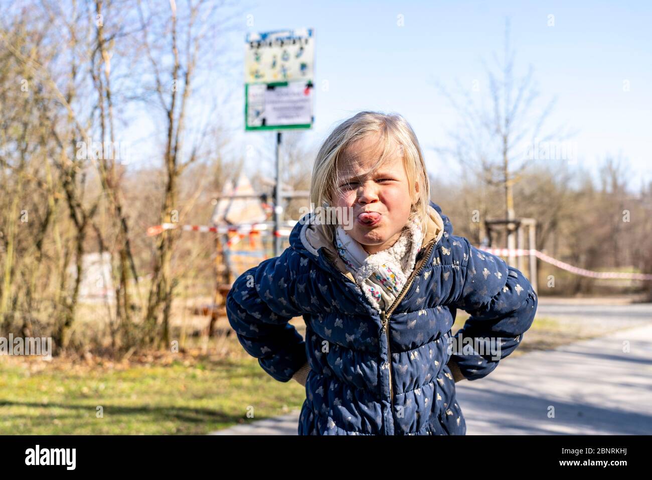 Child in front of a closed playground during the Corona crisis 2020 Stock Photo
