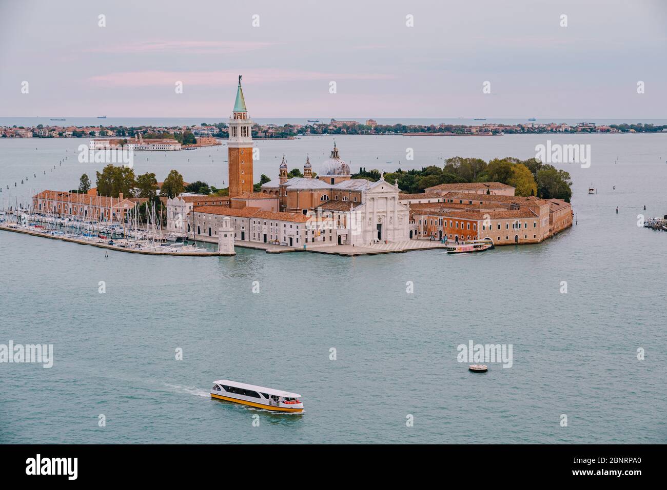 Aerial view from huge cathedral bell tower San Marco Campanile on San Giorgio Maggiore is one of the most famous islands of the Venetian lagoon, in Stock Photo
