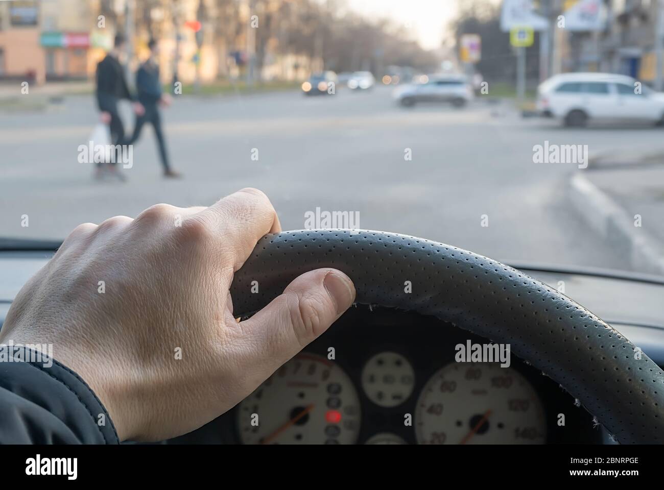 view from the car, the man's hand on the steering wheel of the car