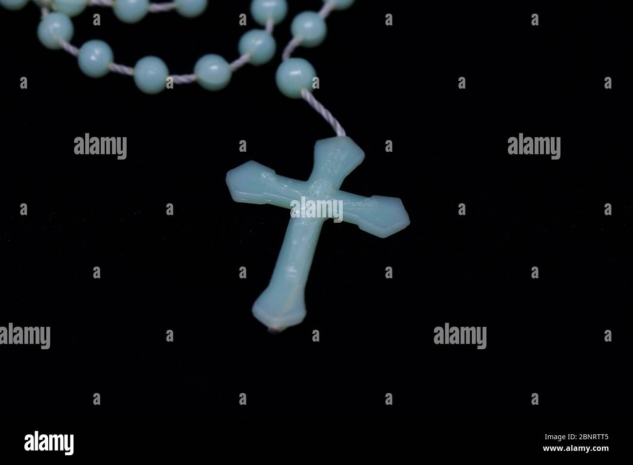 holy rosary isolated on black background, religious concept Stock Photo