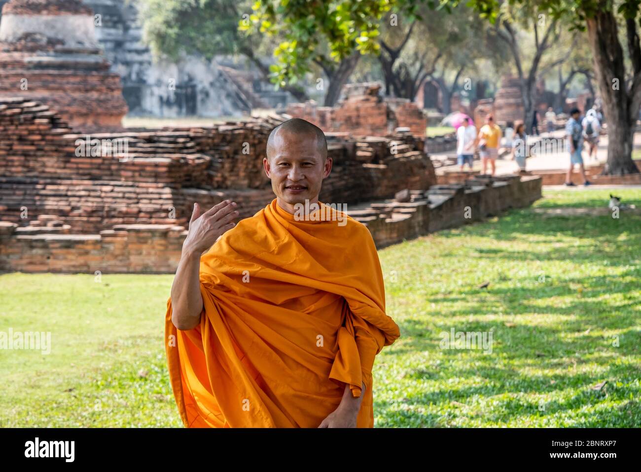 Ayutthaya, Bangkok / Thailand - February 9, 2020: Monk wearing orange clothes and the monk looking at the camera and he is smiling Stock Photo