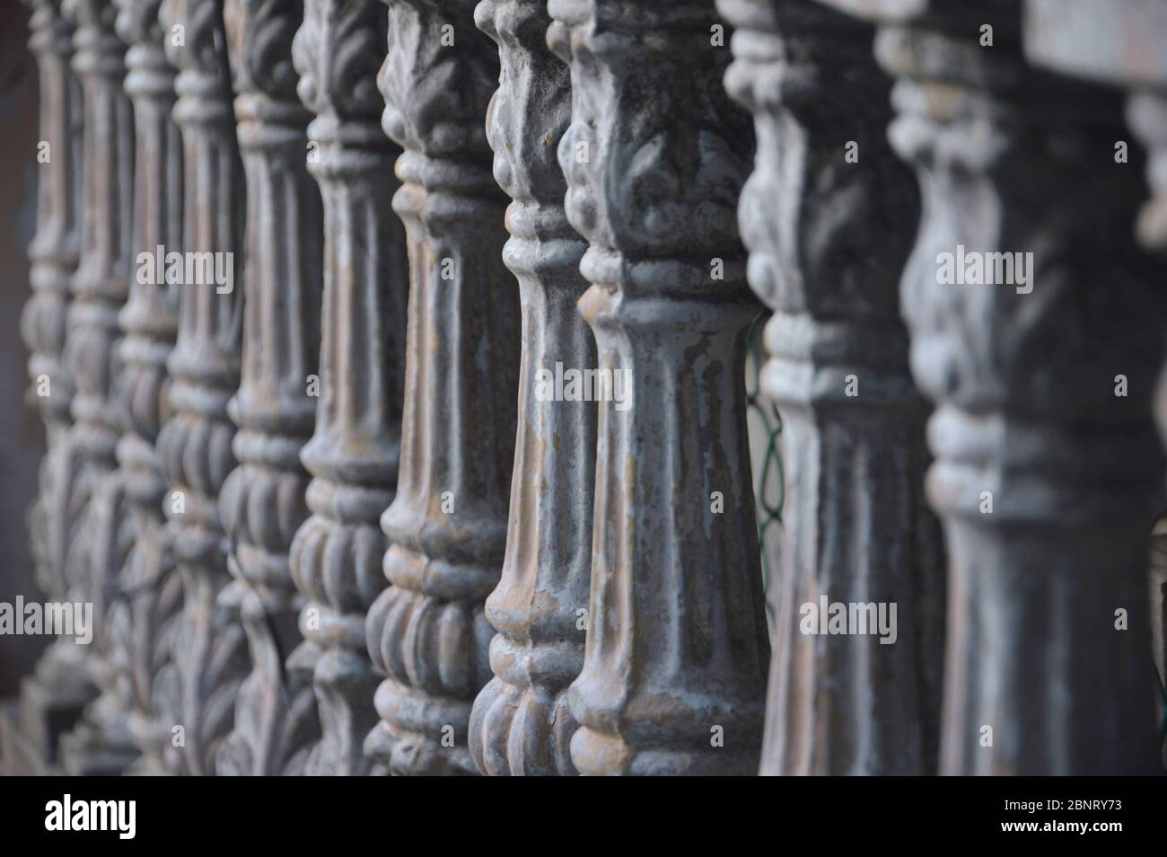 gray concrete fence pillars lined up with selective focus Stock Photo