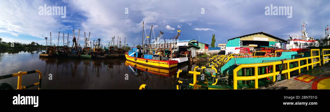 traditional fishing boat berthing at jetty during morning Stock Photo