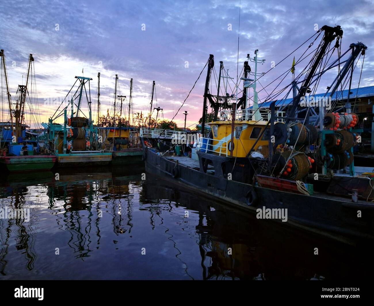traditional fishing boat berthing at jetty during morning Stock Photo