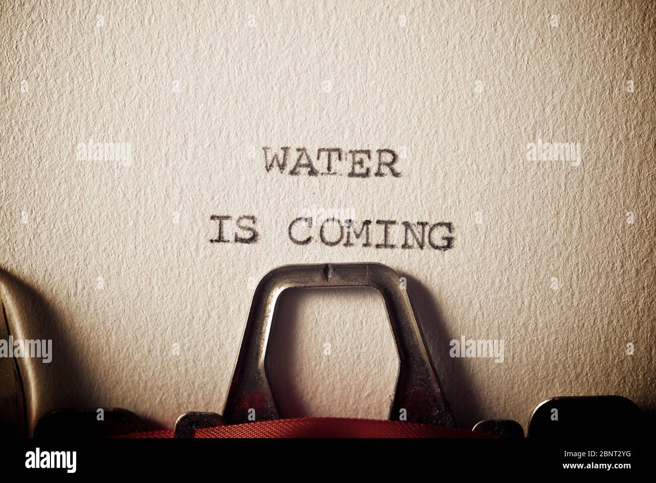 The sentence, water is coming, written with a typewriter Stock Photo