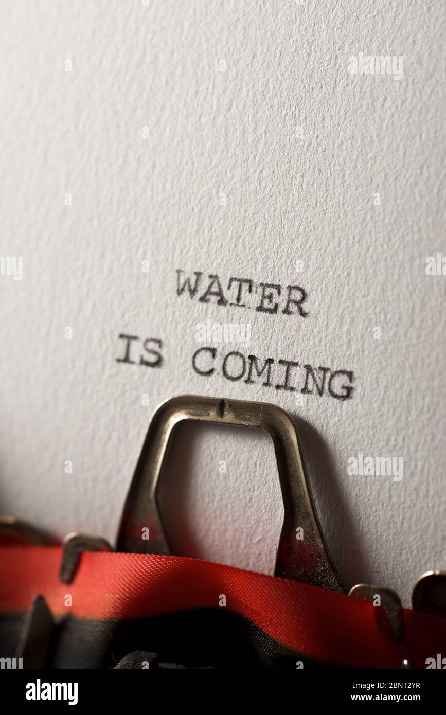 The sentence, water is coming, written with a typewriter Stock Photo