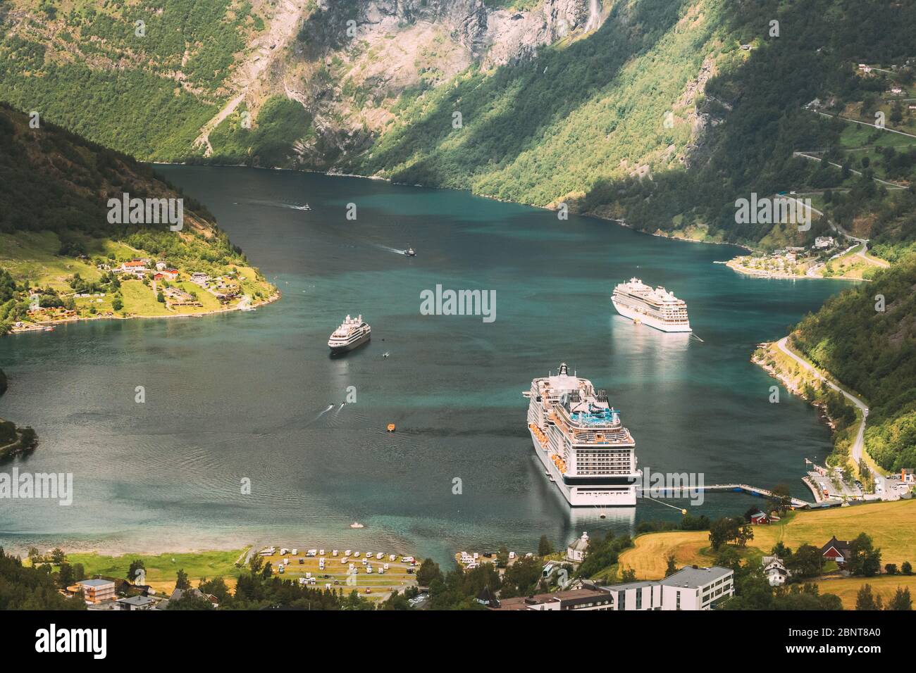 Geirangerfjord, Norway. Aerial View Of Geiranger In Geirangerfjorden In Summer Day. Touristic Ship Ferry Boat Liner Moored Near Geiranger. Famous Norw Stock Photo