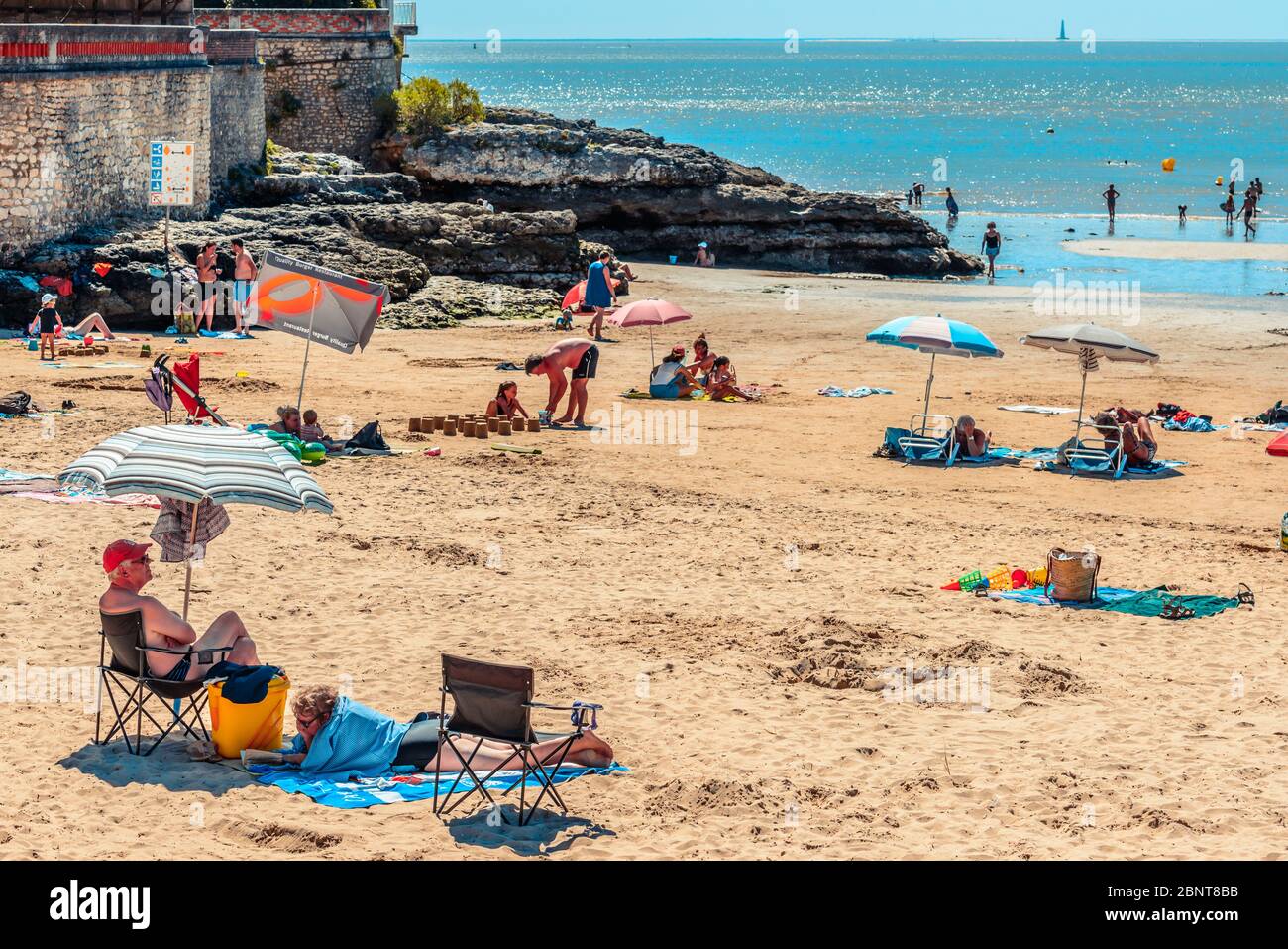 Saint-Palais-sur-Mer, France: Holidaymakers soak up the sun on the Plage du  Bureau beach in the town centre in high season Stock Photo - Alamy