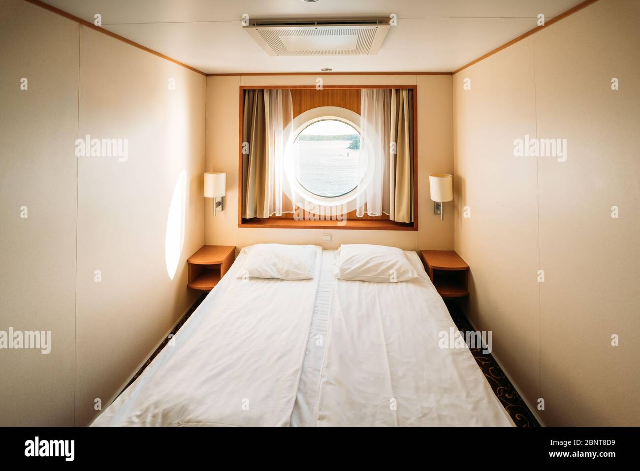 Ship Cabin With Bed And Window With View On Sea. Luxury Cabin On Ferry Boat Or Cruise Liner Stock Photo