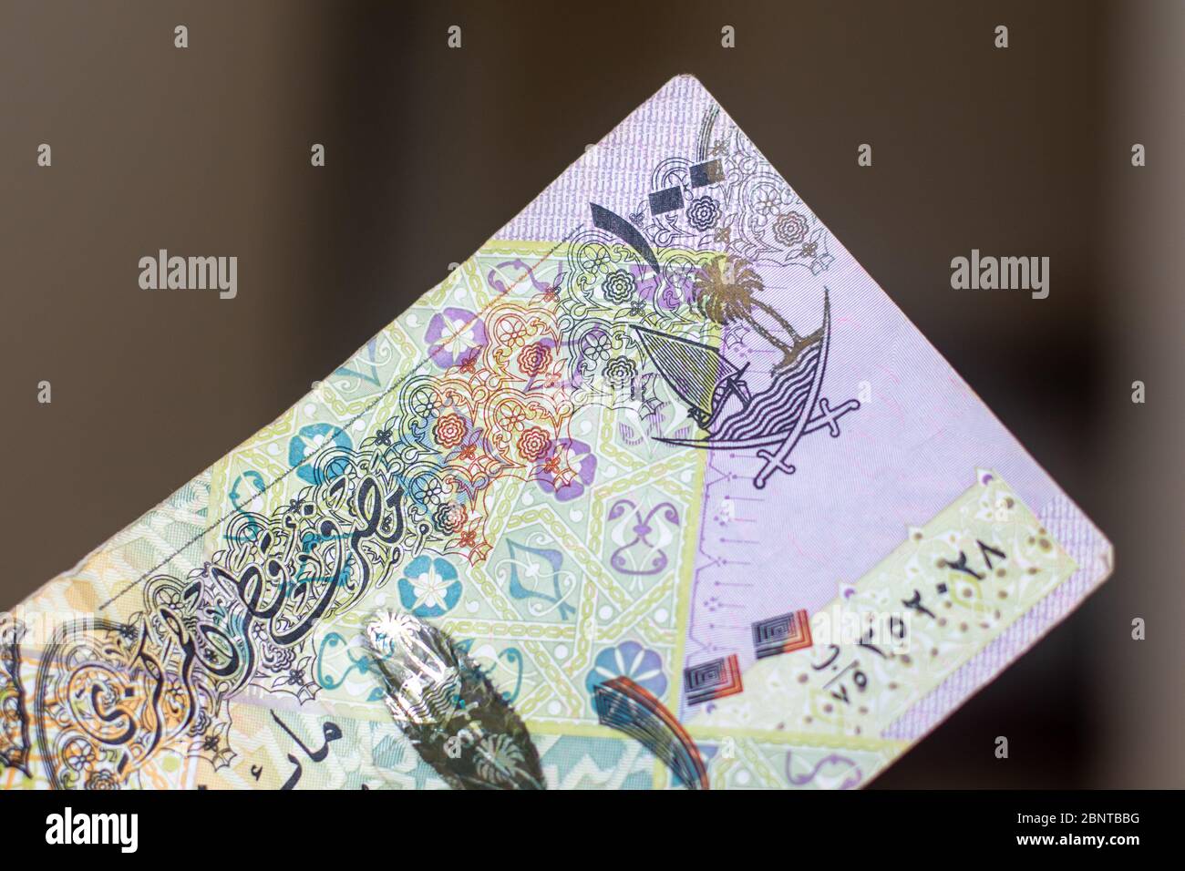 Currency of the Qatar purple one hundred rial or riyal notes spread