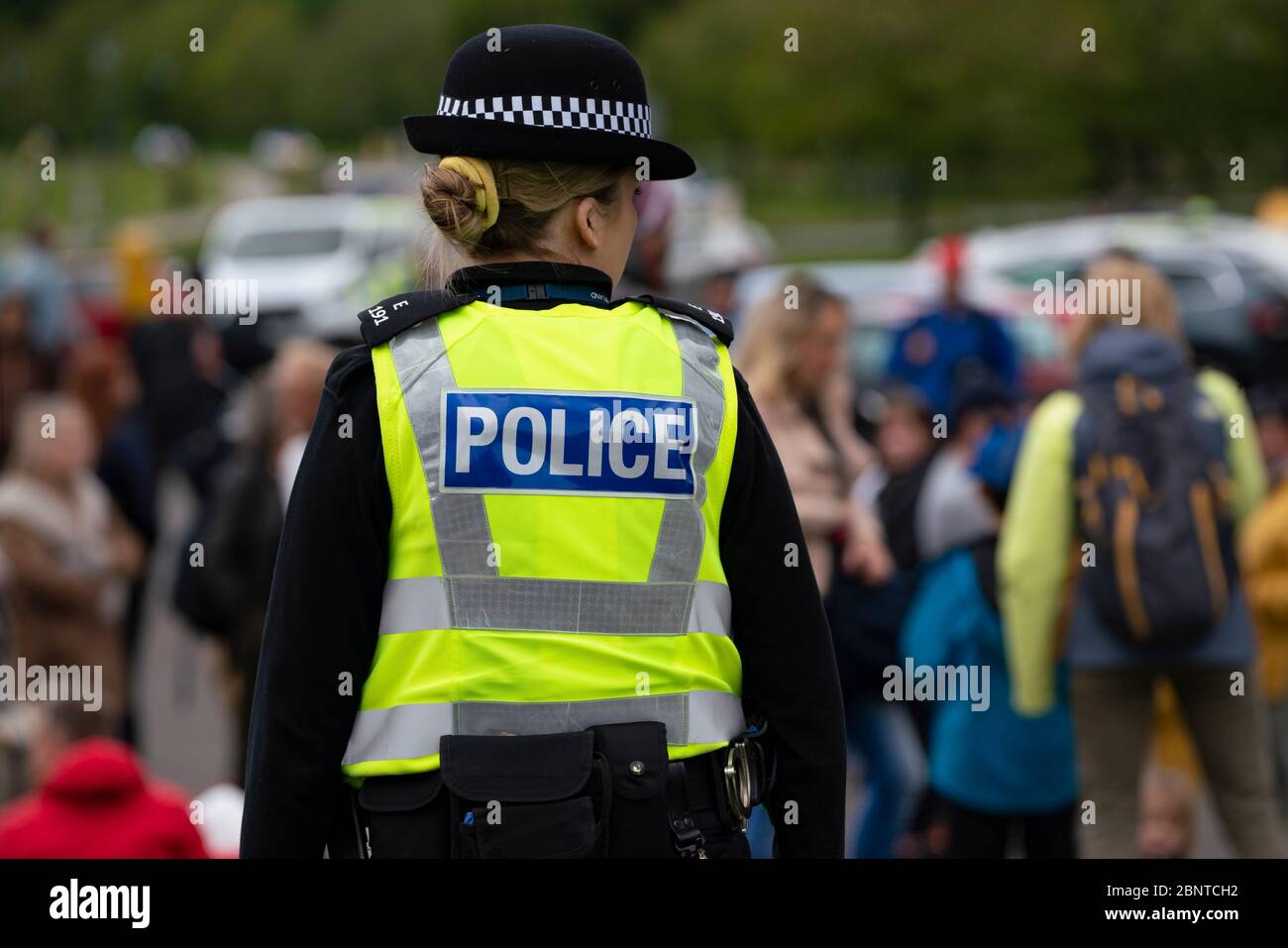 Edinburgh, Scotland, UK. Police watching over a small group of people in Holyrood Park. Possible that one or two members of the public were part of an anti-lockdown protest in the park that was promoted on Facebook this week. No large scale protest is visible in the park at the planned start time however. Iain Masterton/Alamy Live News Stock Photo