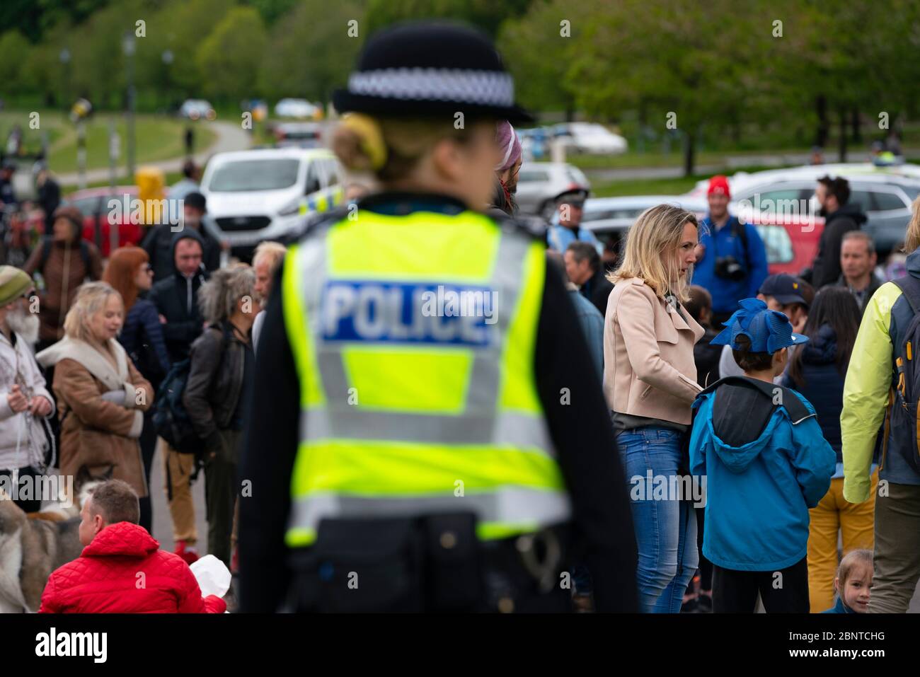 Edinburgh, Scotland, UK. Police watching over a small group of people in Holyrood Park. Possible that one or two members of the public were part of an anti-lockdown protest in the park that was promoted on Facebook this week. No large scale protest is visible in the park at the planned start time however. Iain Masterton/Alamy Live News Stock Photo