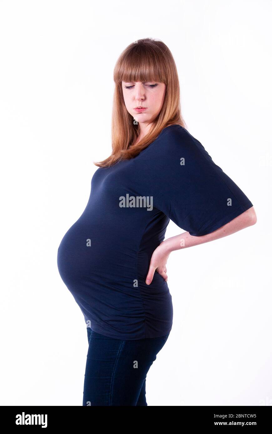 A young pregnant woman with backache. Stock Photo