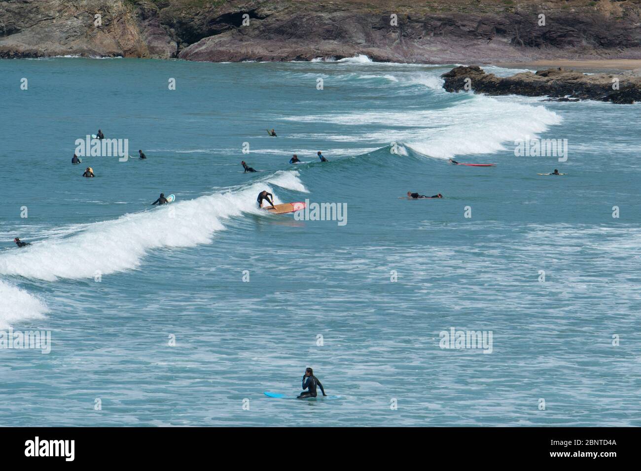 Polzeath, Cornwall, UK. 16th May 2020. UK Weather. The car park and sea at Polzeath was starting to get busy this morning with surfers out making the most of the fine weather. Credit CWPIX / Alamy Live News. Stock Photo