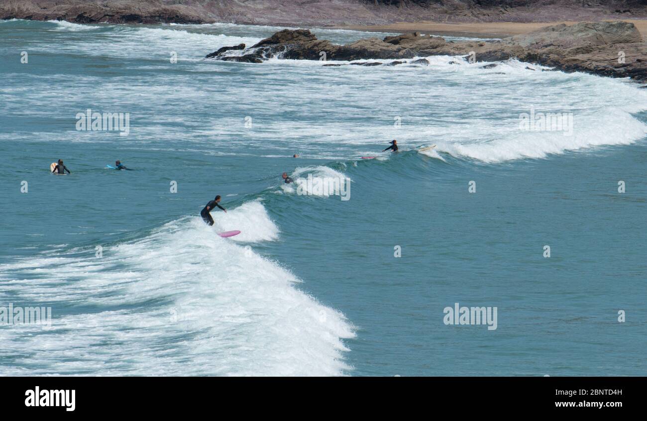 Polzeath, Cornwall, UK. 16th May 2020. UK Weather. The car park and sea at Polzeath was starting to get busy this morning with surfers out making the most of the fine weather. Credit CWPIX / Alamy Live News. Stock Photo