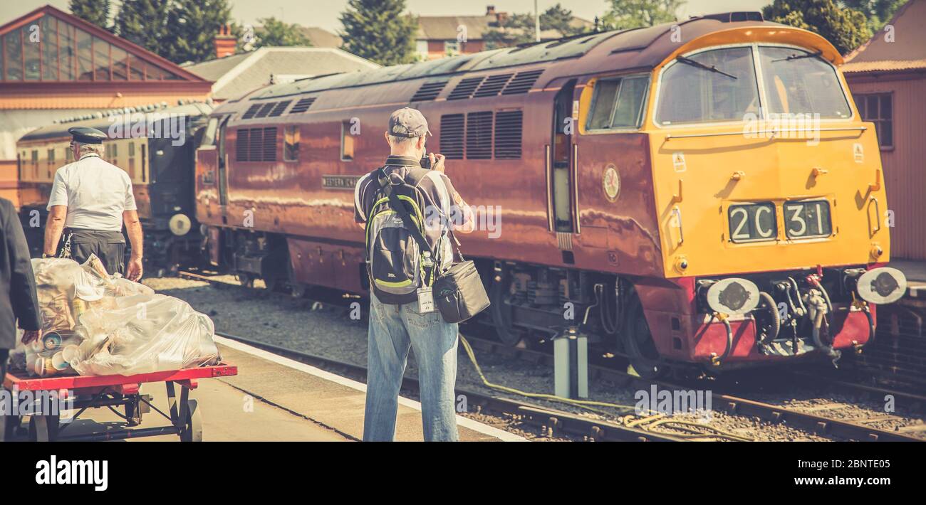 Diesel gala, Severn Valley Railway, Kidderminster station. Rail enthusiast trainspotter taking photograph of diesel locomotive Western Champion D1015. Stock Photo