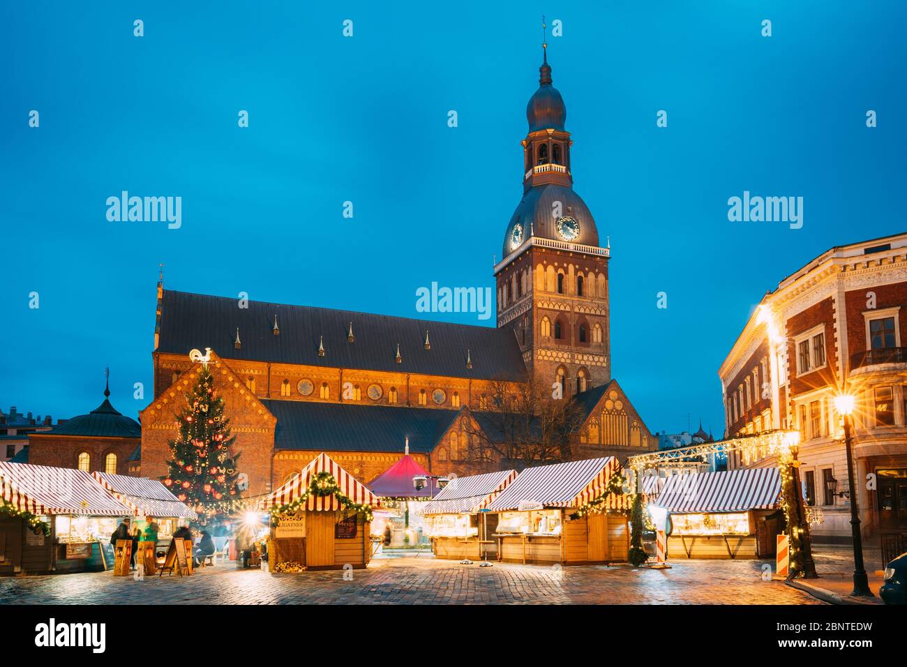 Riga, Latvia - December 13, 2016: Christmas Market On Dome Square With Riga Dome Cathedral. Christmas Tree And Trading Houses. Famous Landmark At Wint Stock Photo