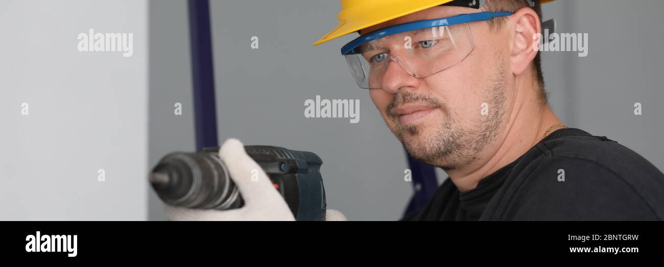 Man in protective helmet and eyewear Stock Photo