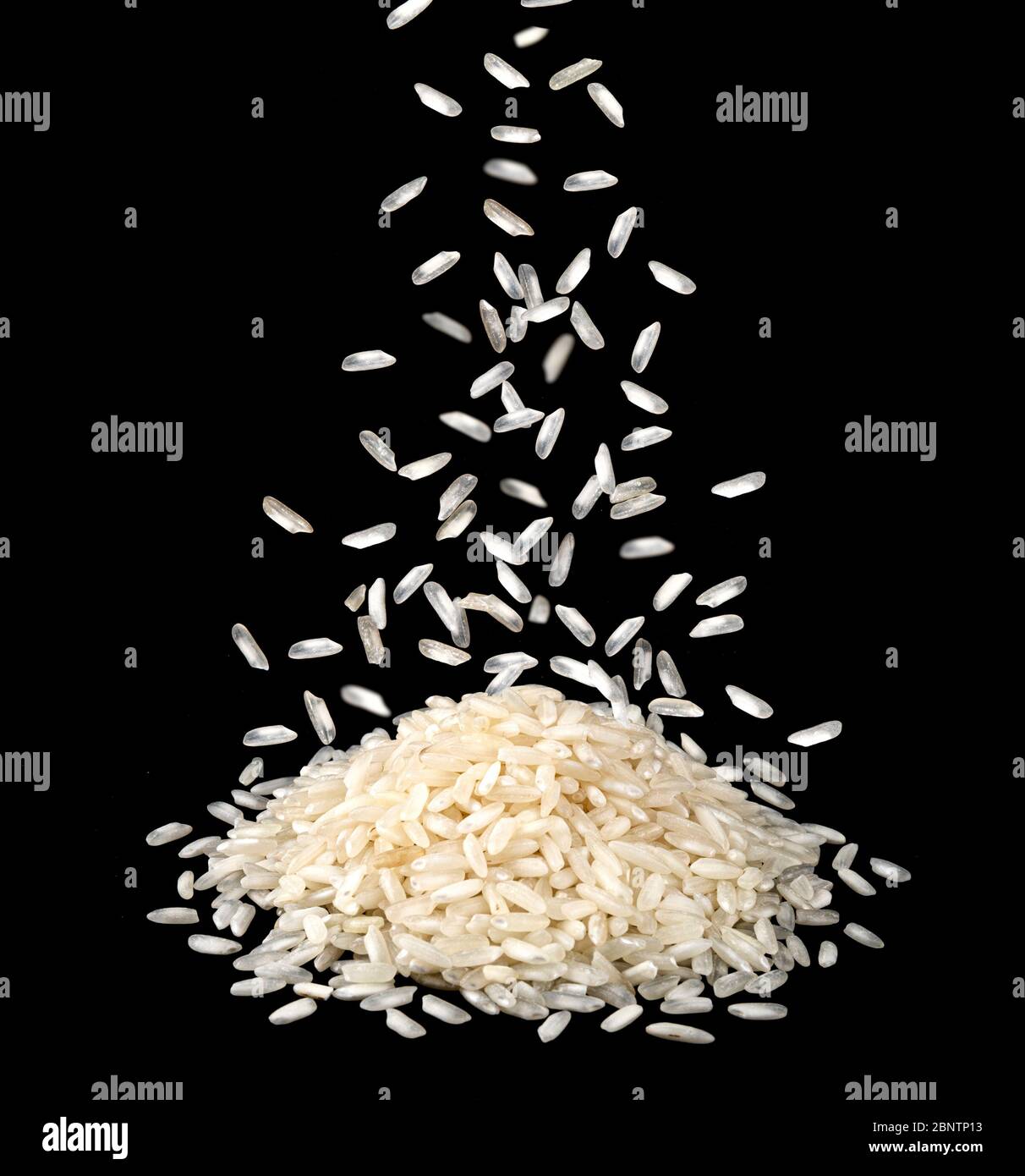 Falling dry rice grains isolated on black background Stock Photo Alamy