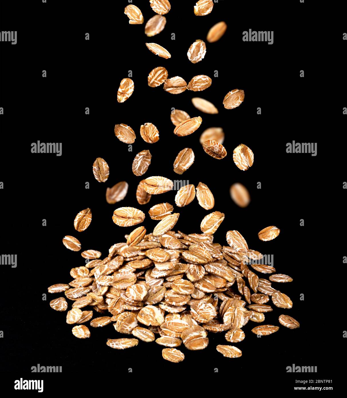 Heap of oat flakes isolated on black background Stock Photo