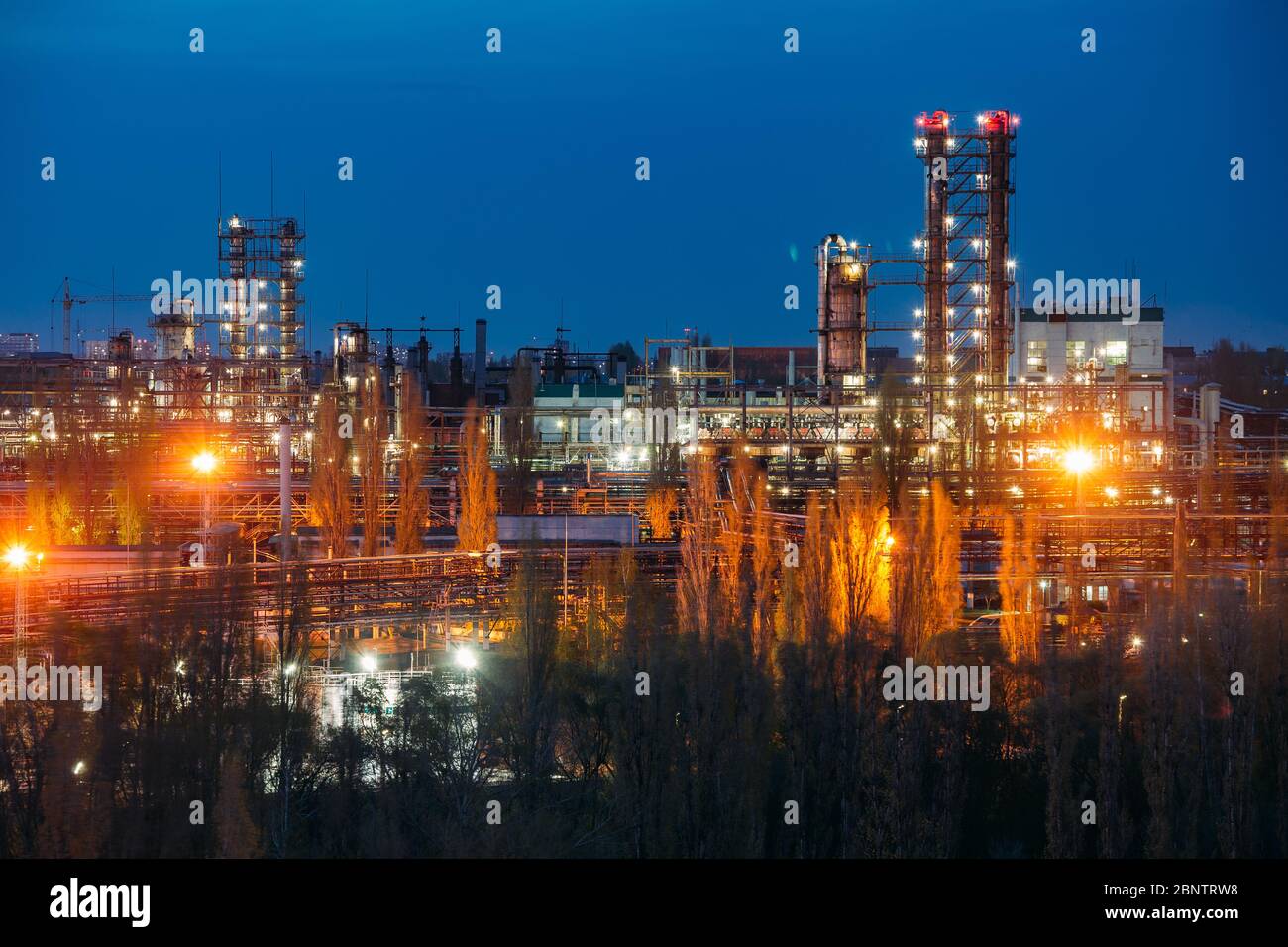 Chemical factory at summer night. Rectification towers Stock Photo