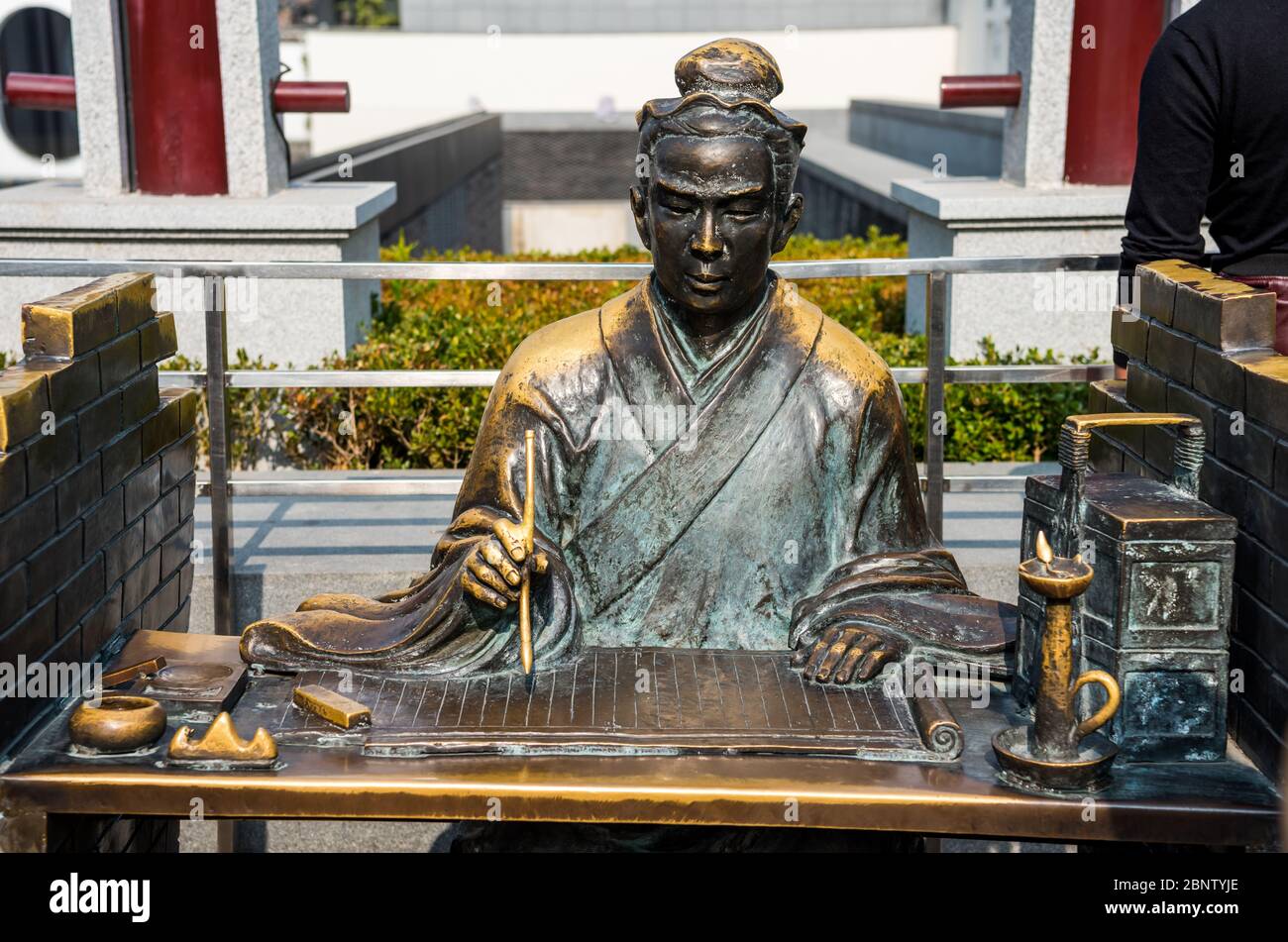 Statue of Acient Chinese Scholar writing on the bable on the bamboo