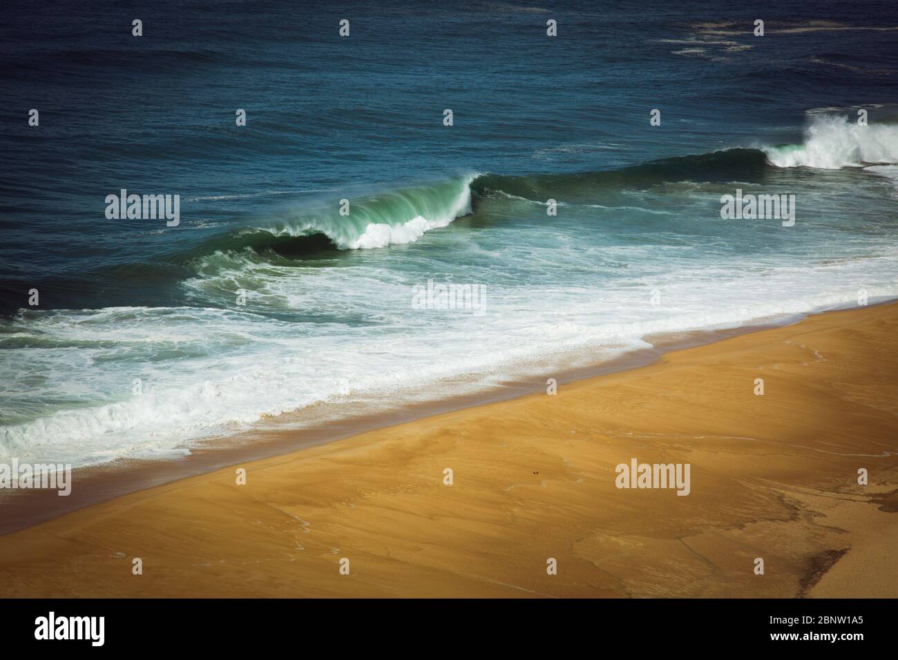 Aerial view of sandy North beach and Atlantc Ocean with big waves in Nazare, Portugal Stock Photo