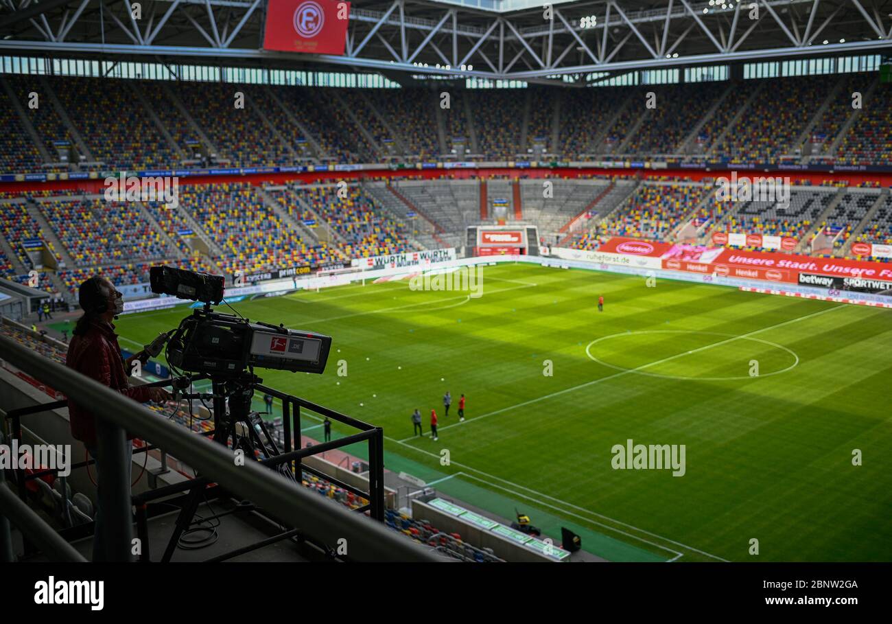 Germany. 16th May, 2020. Football: Bundesliga, Fortuna Düsseldorf -  Borussia Mönchengladbach, 26th matchday in the Merkur-Spiel-Arena. A  cameraman stands in the empty stadium. Credit: Sascha  Schuermann/AFP-Pool/dpa - only for use in accordance